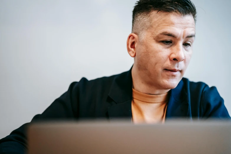 a man sitting in front of a laptop computer