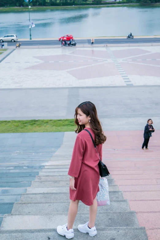 a woman standing at the top of a flight of stairs, inspired by Cheng Jiasui, pexels contest winner, pyongyang city, girl with brown hair, square, low quality photo