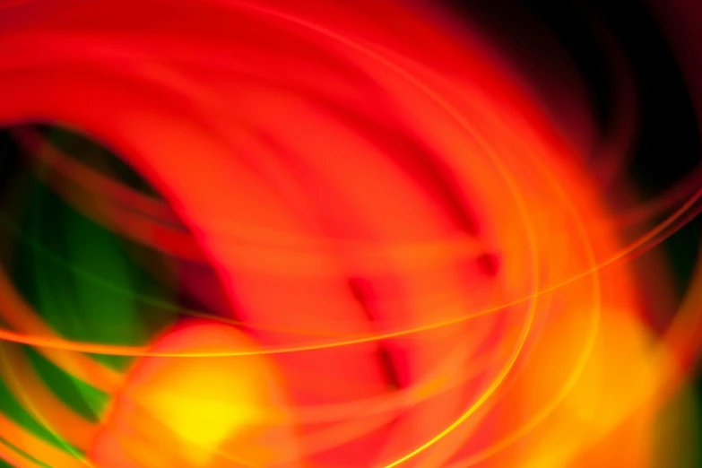 a blurry photo of an orange and green object, by Jan Rustem, lyrical abstraction, red and yellow light, whirling, multicoloured, red yellow
