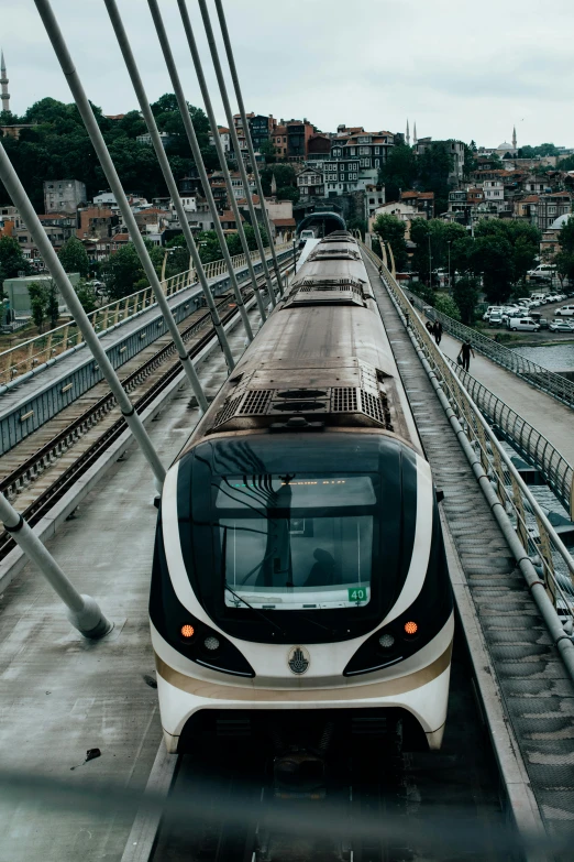 a large long train on a steel track, by Matija Jama, renaissance, all buildings on bridge, slide show, instagram story, bosnian