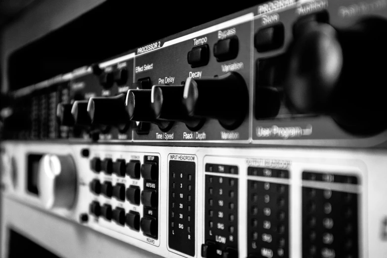 a close up of a bunch of electronic equipment, a black and white photo, pexels, analogic synthsizer, rack, front closeup, maverick studio