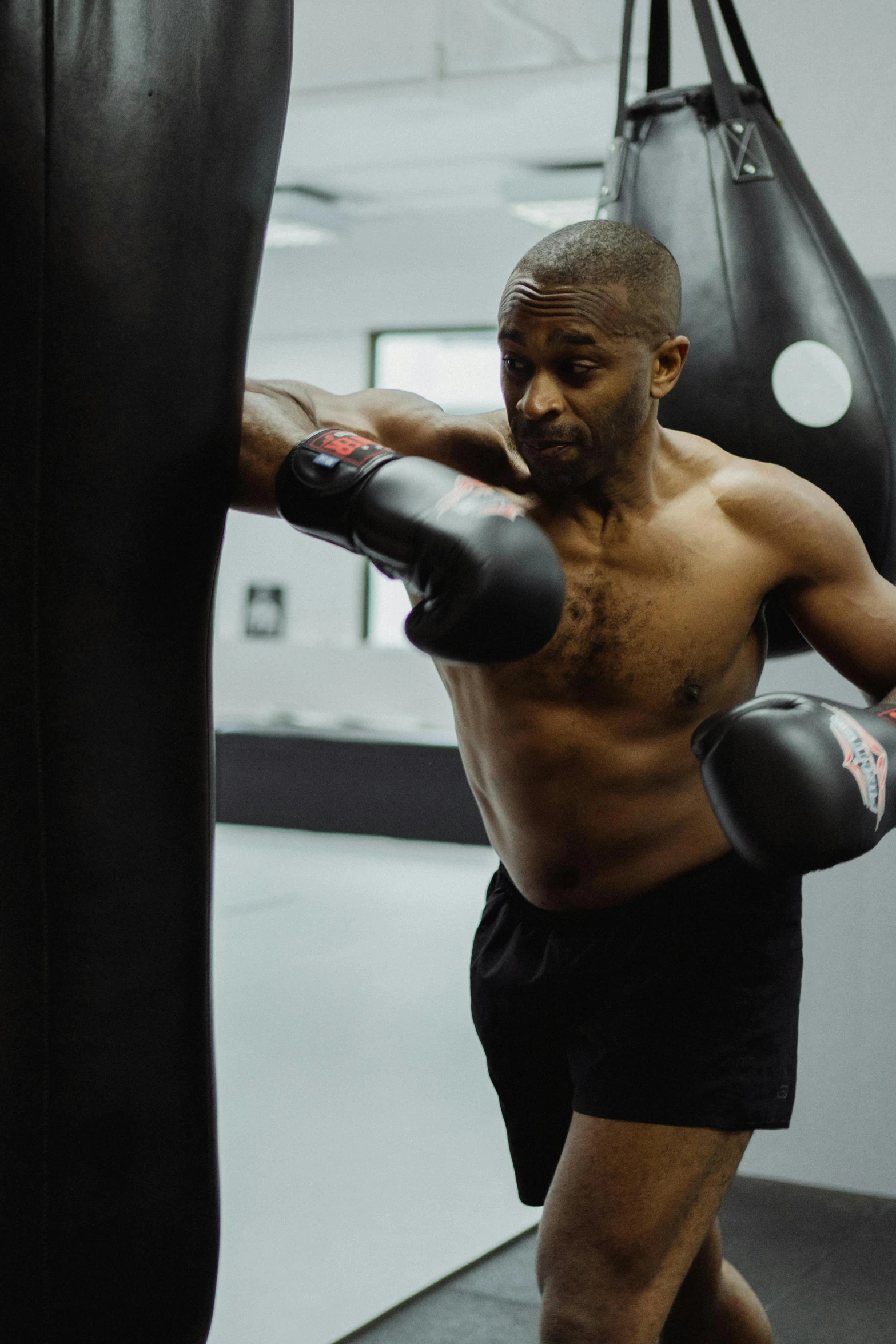 a man standing next to a punching bag, mkbhd, pulling the move'the banshee ', profile image, raphael lecoste