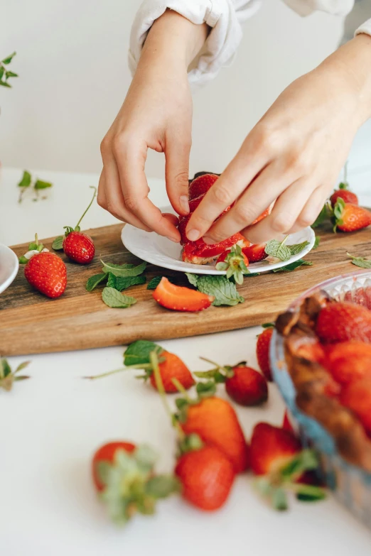 a close up of a person cutting strawberries on a cutting board, by Lucette Barker, desserts, cutlery, mix, fruit trees