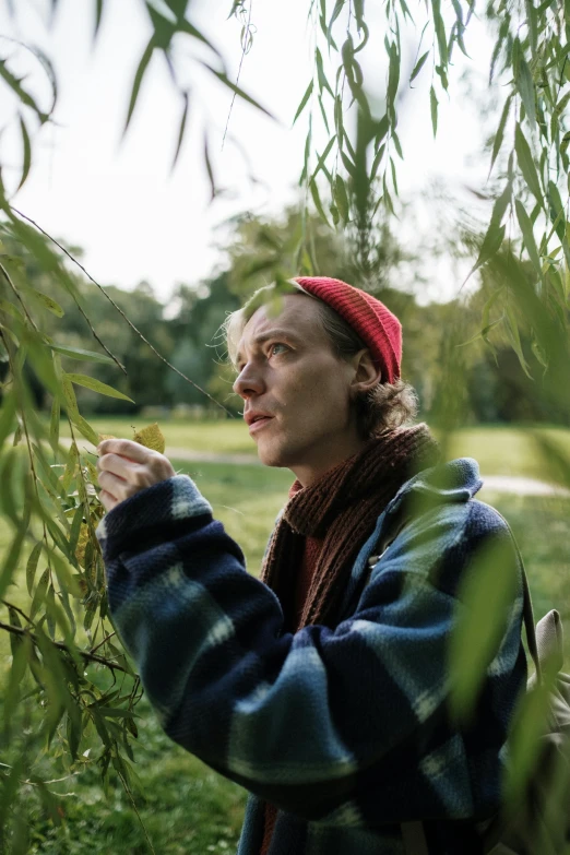 a man that is standing under a tree, jamie campbell bower, willow plant, queer woman, profile image