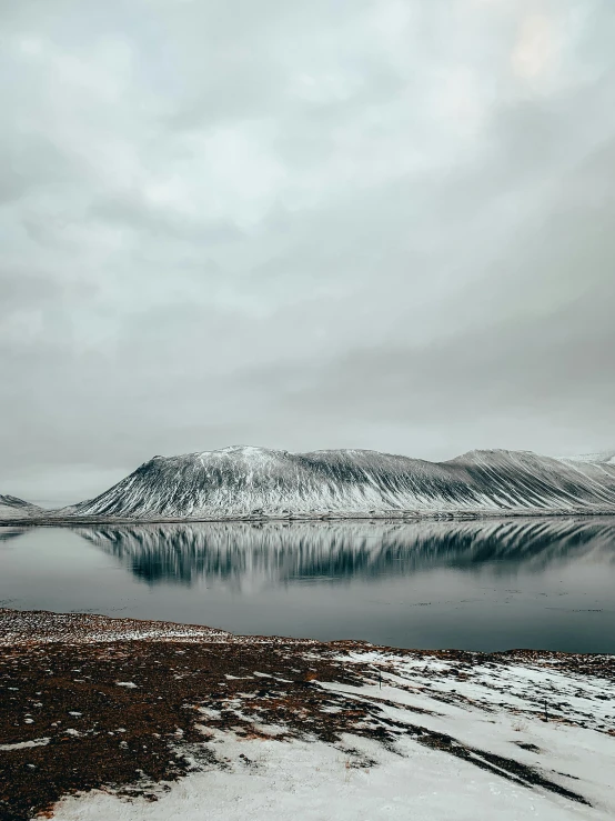 a large body of water surrounded by snow