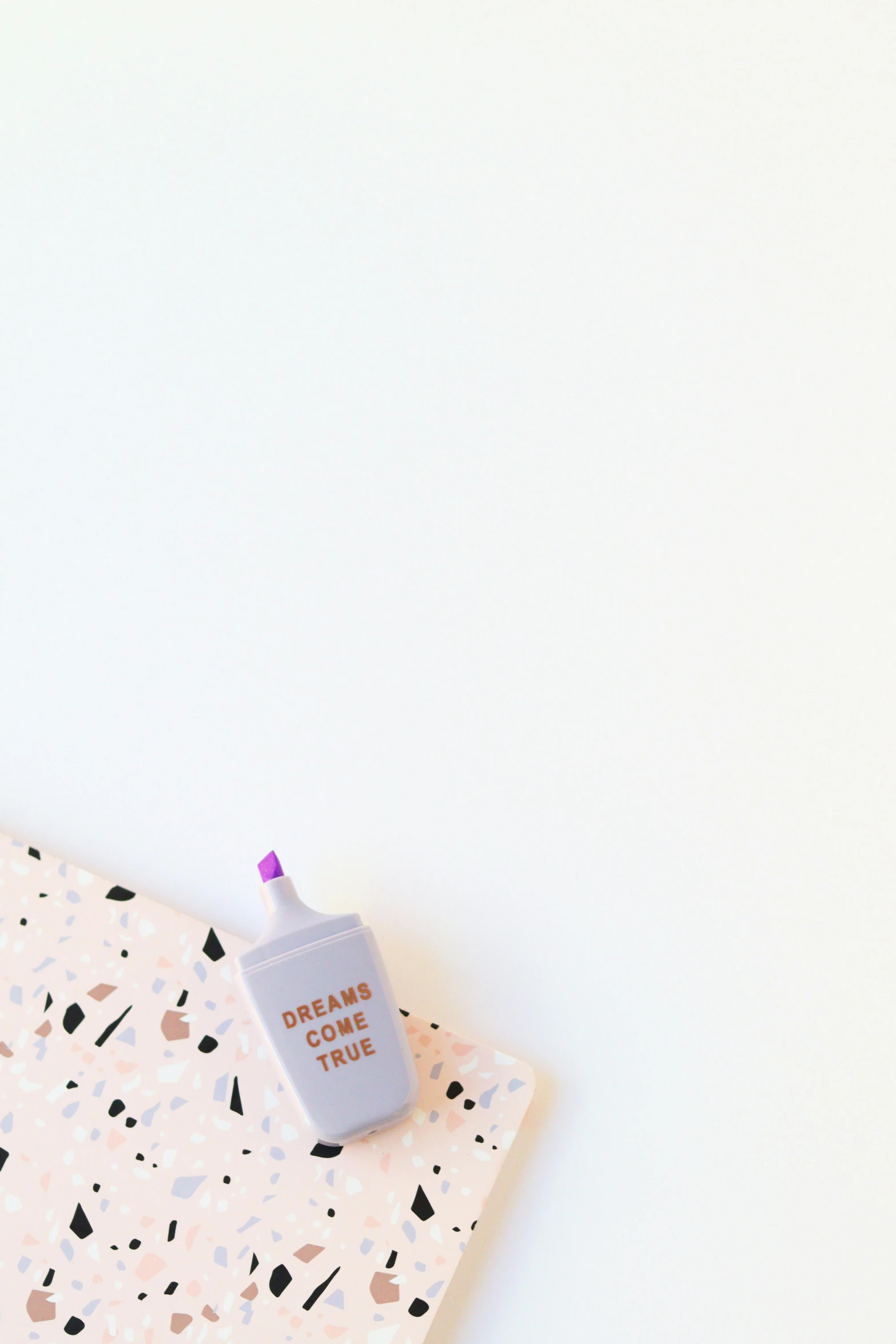 a notebook with a pen sitting on top of it, by Nicolette Macnamara, trending on unsplash, graffiti, carrying a bottle of perfume, pastel pink concrete, design on a white background, cutecore