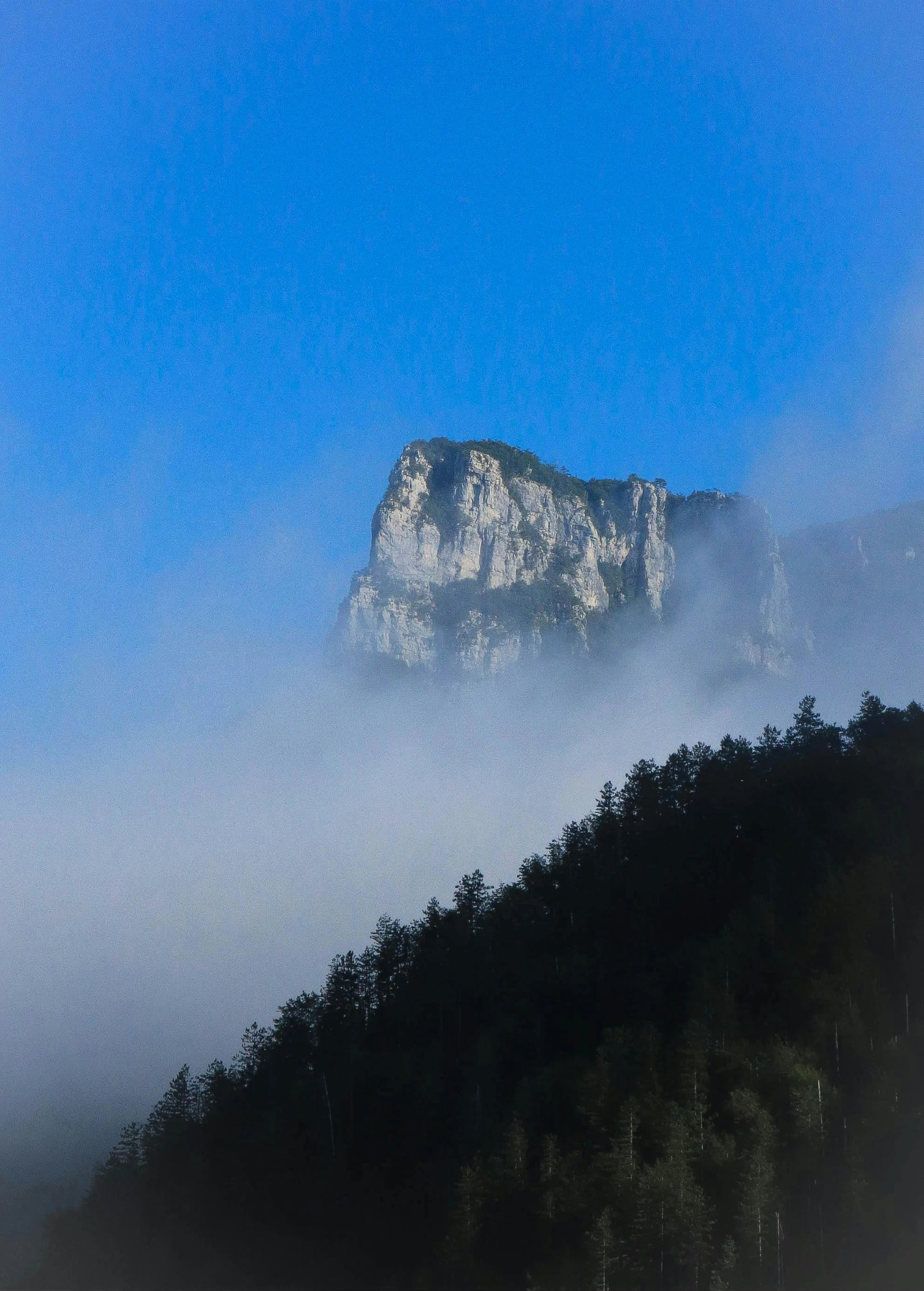 a picture of mountains in the distance with mist