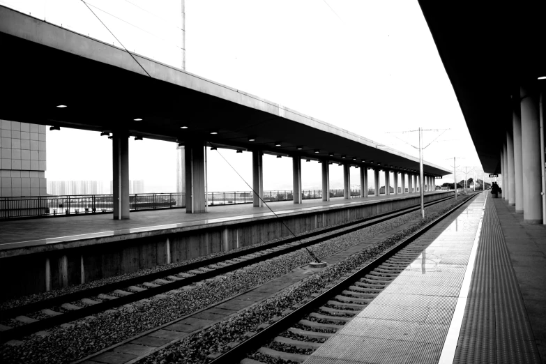 a black and white photo of a train station, postminimalism, mid shot photo