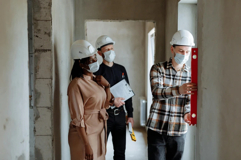 a group of construction workers standing next to each other, pexels contest winner, masked person in corner, in house, investigation, fashionable