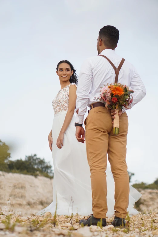 a man and a woman standing next to each other, inspired by Fede Galizia, unsplash, standing on rocky ground, bouquets, cinematic outfit photo, linen