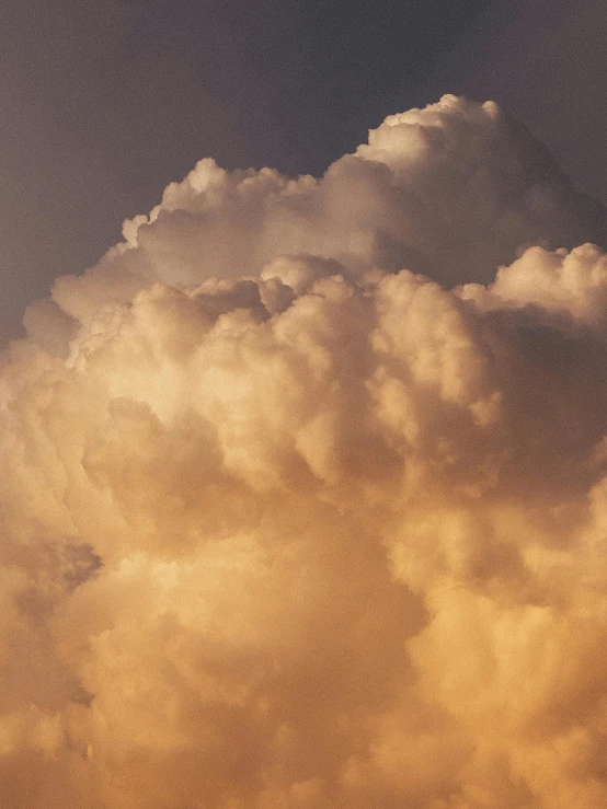 airplane in the sky with clouds behind it