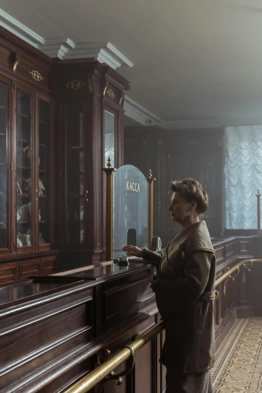 a man that is standing in front of a bar, by Emma Andijewska, art nouveau, cinematic luts, old lady, set inside of the bank, hazy