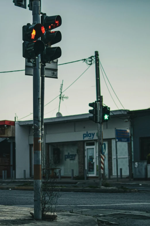 a traffic light sitting on the side of a road, an album cover, trending on unsplash, postminimalism, north melbourne street, ruined town, low quality photo, lots of signs and shops