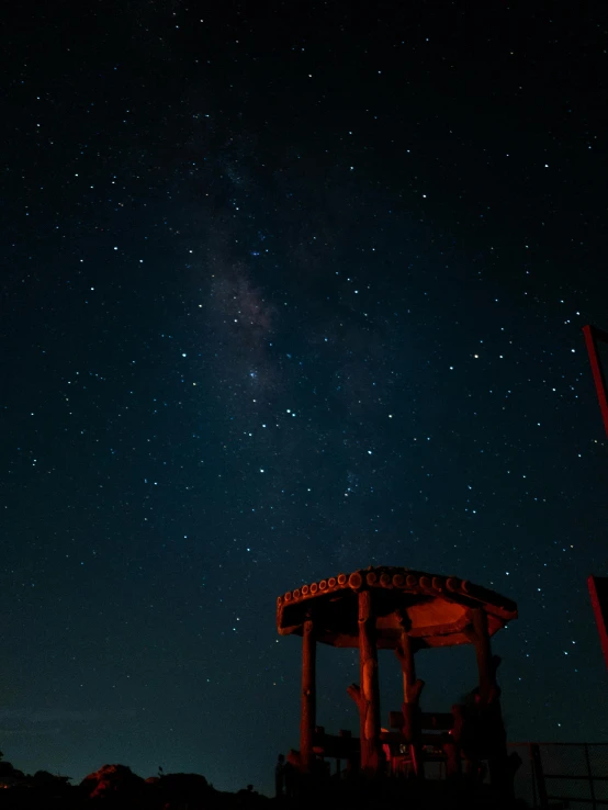 a gazebo at night with the milky in the background, pexels contest winner, star charts, space station planet afar, brown, ancient