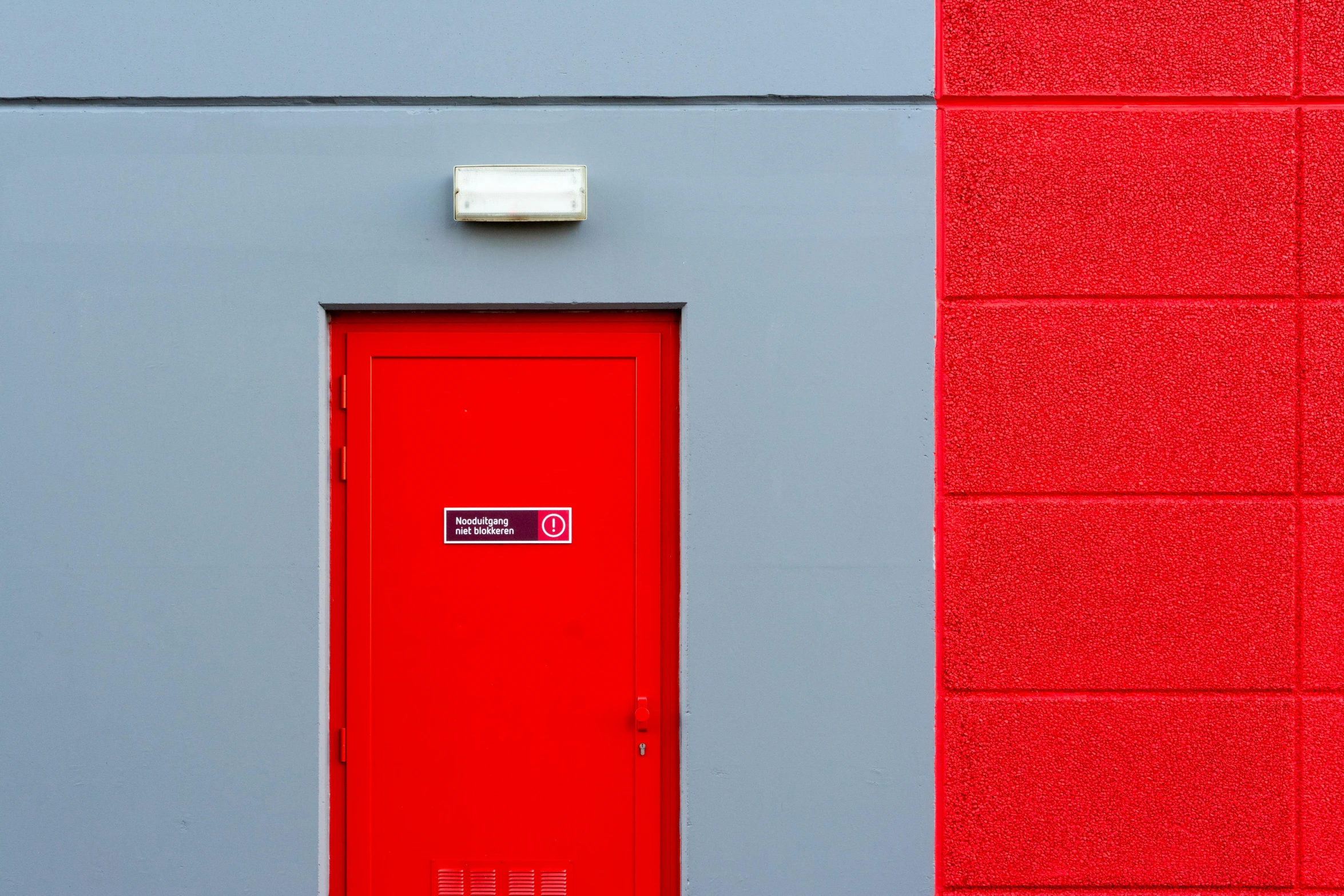 a fire hydrant sitting in front of a red door, a photo, inspired by Bauhaus, postminimalism, rectangle, red, door, bright signage