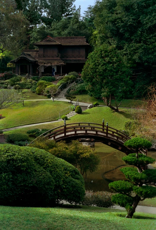 a bridge leads to the house over a stream