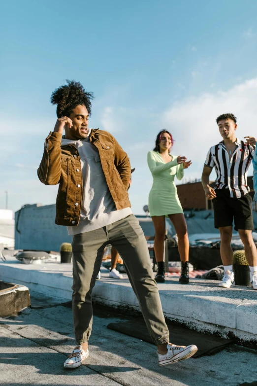 a group of people standing on top of a roof, an album cover, trending on pexels, happening, diverse outfits, performing a music video, ( ( theatrical ) ), teenager hangout spot