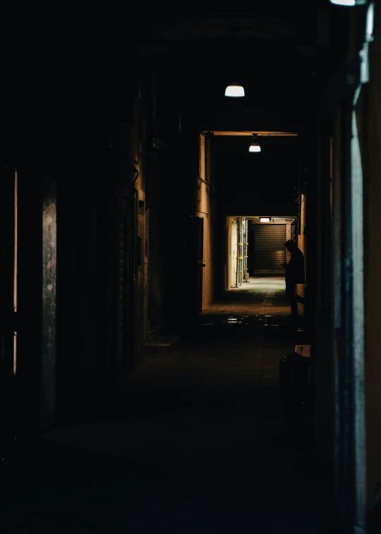 a dark hallway with a light at the end of it, a picture, inspired by Elsa Bleda, unsplash contest winner, old jeddah city alley, instagram photo, inside a warehouse, promo image