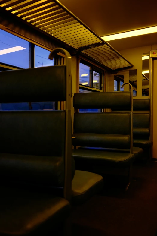 a row of black seats on a subway or train