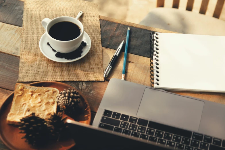 a laptop computer sitting on top of a wooden table next to a cup of coffee, trending on pexels, writing a letter, 9 9 designs, black and brown colors, avatar image