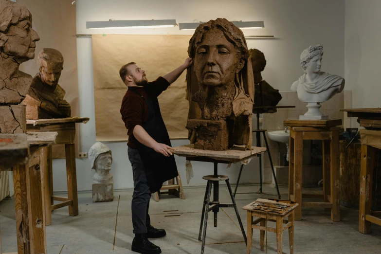 a man that is standing in front of a statue, a marble sculpture, arbeitsrat für kunst, beautiful studio face, clay animation, national art school mfa, art history 8 k