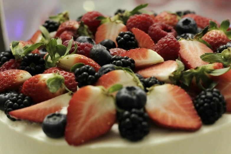 a close up of a cake with strawberries and blackberries, by Tom Bonson, pexels, hurufiyya, colorful”, hd footage, fan favorite, white