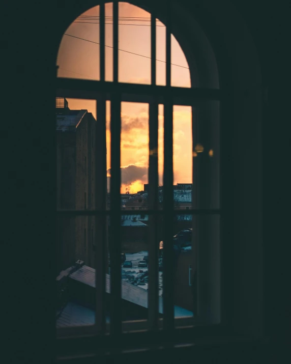 a view of a sunset through a window, inspired by Elsa Bleda, unsplash contest winner, large windows to french town, trending on vsco, overlooking, high light on the left