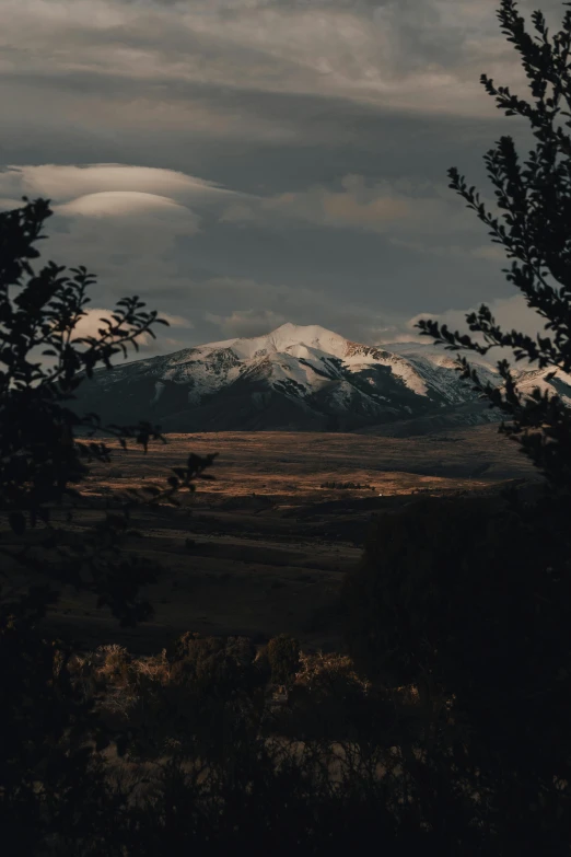 a mountain range that is under a cloudy sky