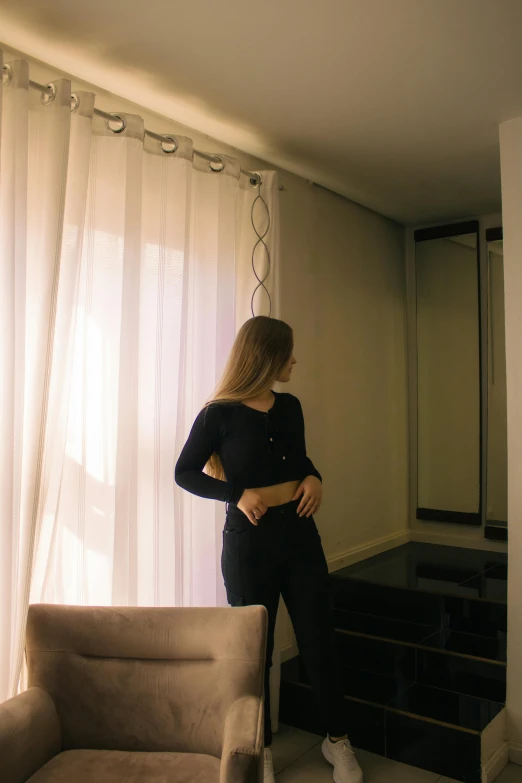 woman in living room standing with legs on a chair