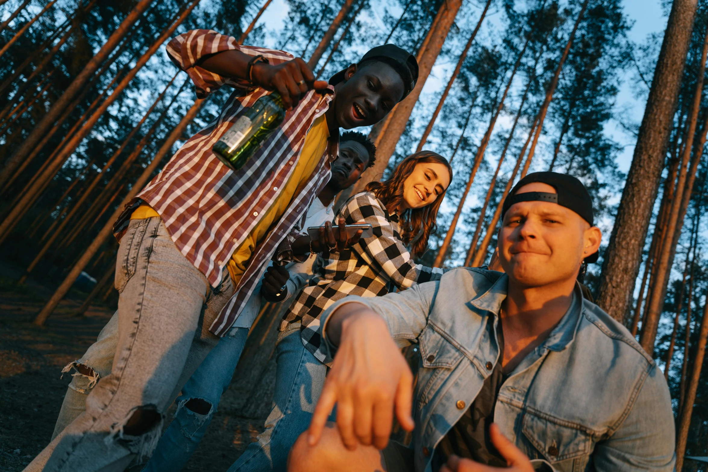 a group of men standing next to each other in a forest, pexels contest winner, photograph of three ravers, redneck, mix of ethnicities and genders, high quality product image”