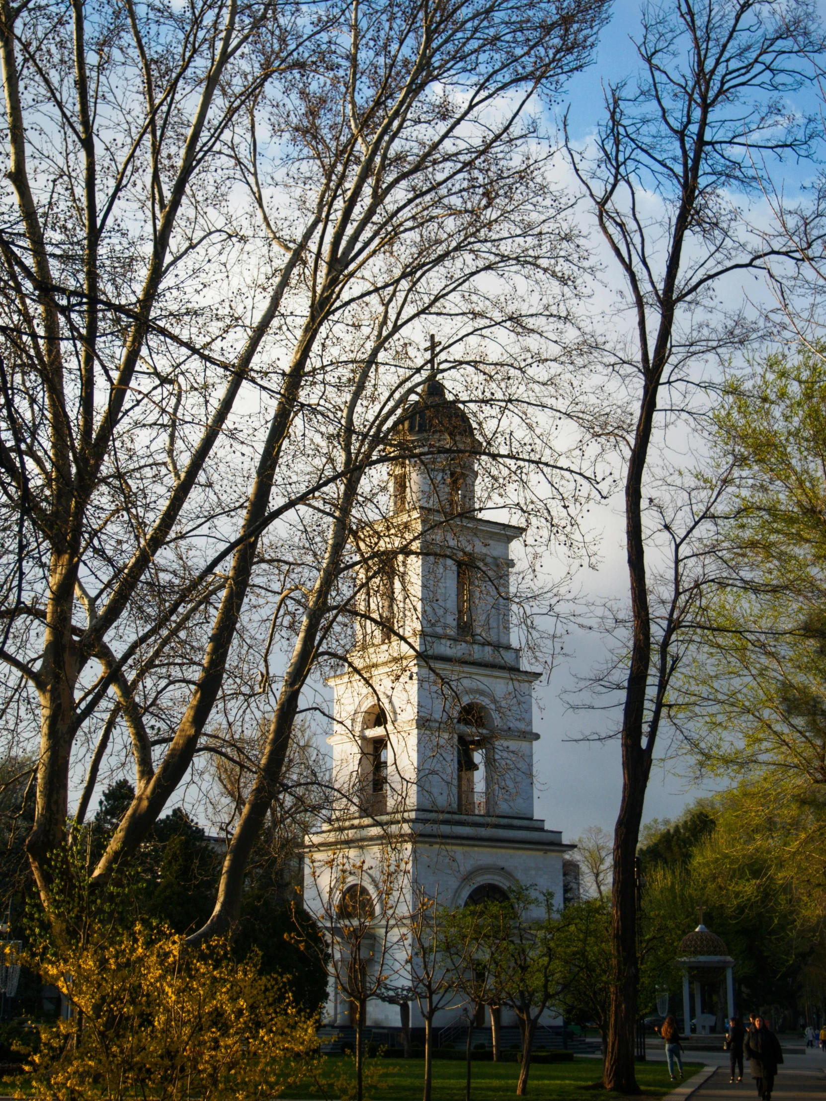 a clock tower in the middle of a park, inspired by Konstantin Vasilyev, pexels contest winner, romanticism, rostov, in a monestry natural lighting, great light and shadows”, may)