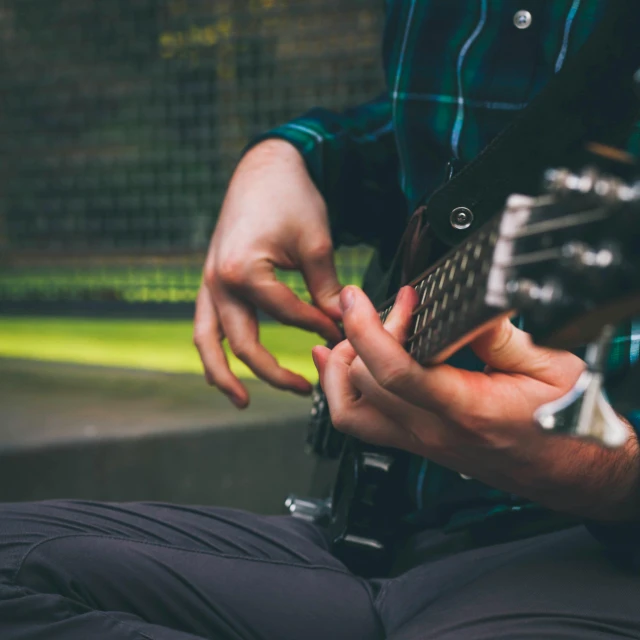 a close up of a person playing a guitar, pexels contest winner, sitting with wrists together, vibrating, instagram post, 15081959 21121991 01012000 4k