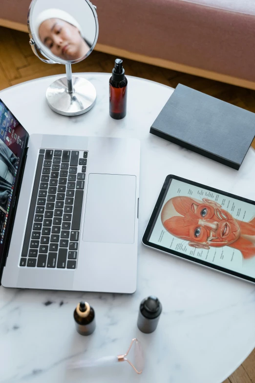 a laptop computer sitting on top of a white table, a portrait, by Adam Rex, muscular system reference, skincare, books on side table, overview