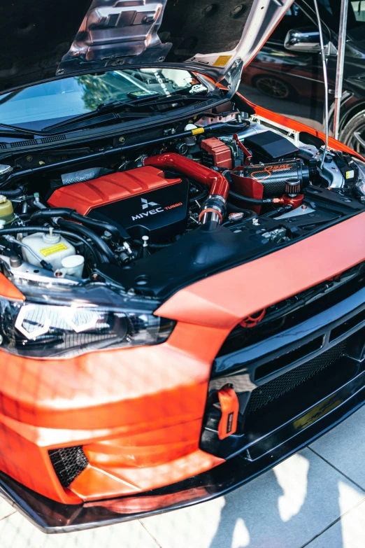 a close up of a car with its hood open, performance, square, vibrant orange, rb 6 s