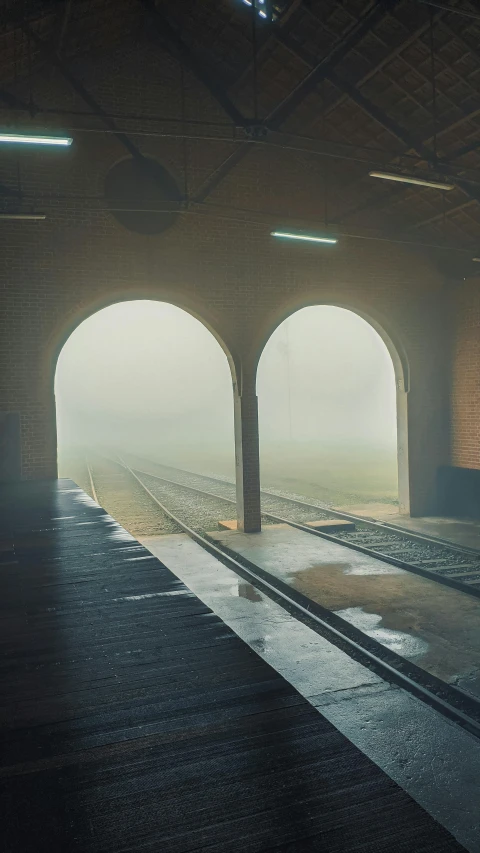 a train is coming out of a tunnel, by Lucia Peka, unsplash contest winner, conceptual art, floor fog, clemens ascher, train station, cinematic composition 8 k
