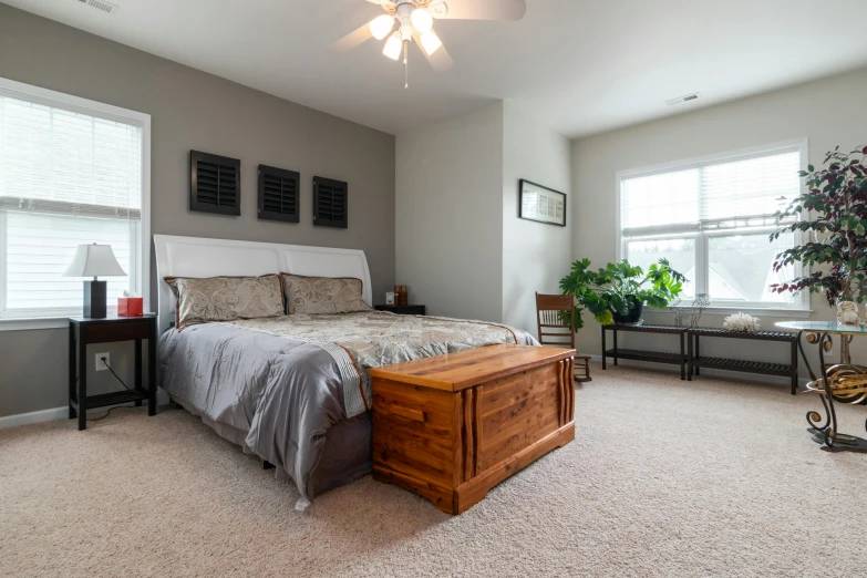 a bedroom with a bed and chair near a window