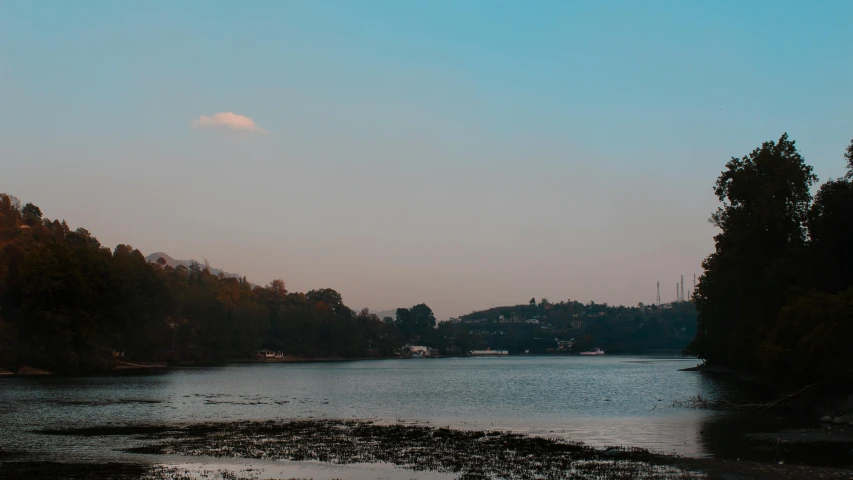 a large body of water surrounded by trees, an album cover, pexels contest winner, hurufiyya, guwahati, panorama distant view, late afternoon light, today\'s featured photograph 4k