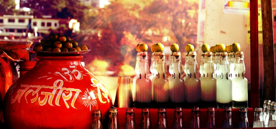 a red vase sitting on top of a wooden table, a tilt shift photo, by Julia Pishtar, happening, beer bottles, fallas party figures, golden hour in beijing, mexican folklore