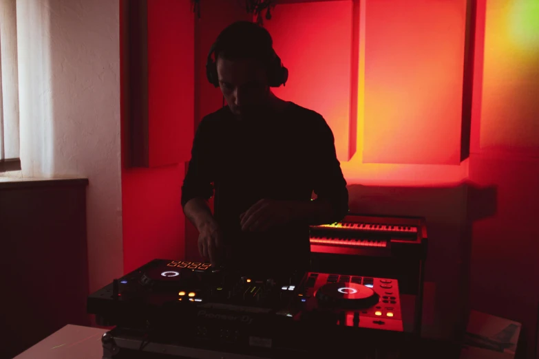 a man that is standing in front of a mixer, an album cover, unsplash, purism, red leds, dj at a party, ignant, in house