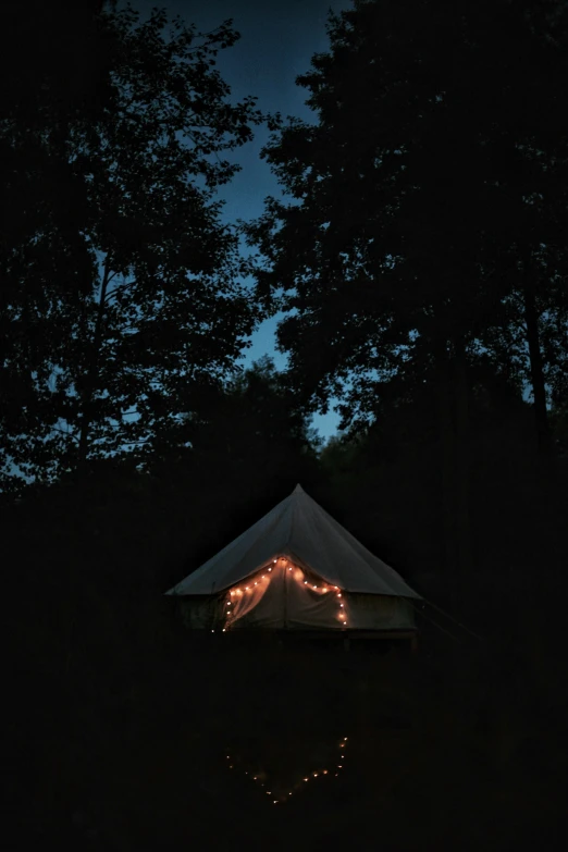 a tent is lit up in the dark, poster art, by Jessie Algie, unsplash contest winner, renaissance, late summer evening, gray, holiday, low quality photo