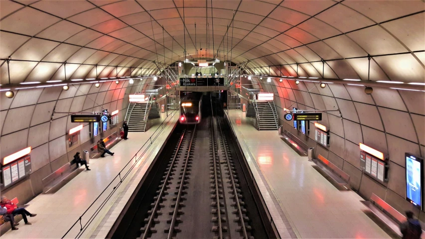 a train pulling into a train station next to a platform, by Jens Søndergaard, flickr, futuristic cyber subway station, norrlandsskog, thumbnail, demur