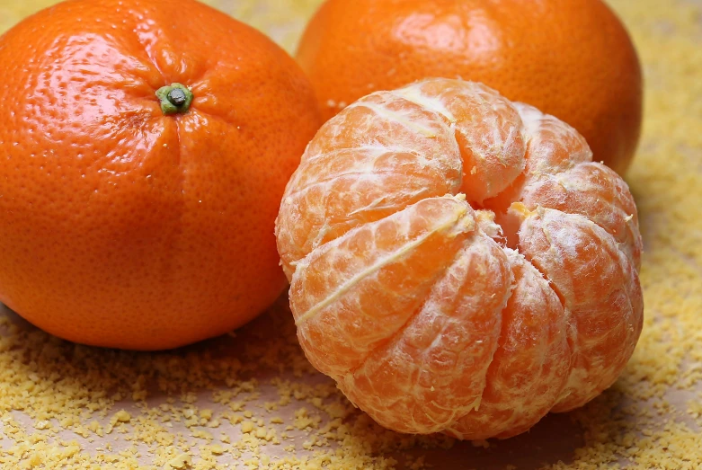 a couple of oranges sitting on top of a table, a stipple, pexels, 🦩🪐🐞👩🏻🦳, medium close up shot, local foods, citrinitas