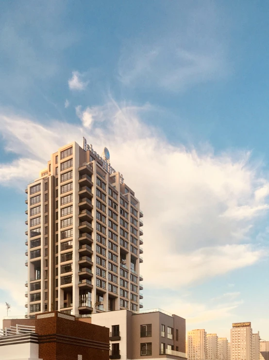 a very tall building sitting in the middle of a city, inspired by Ricardo Bofill, renaissance, blue sky, thumbnail, exterior shot, evening light