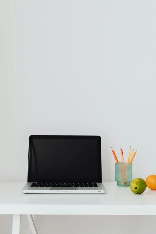 a laptop computer sitting on top of a white desk, by Carey Morris, minimalism, fruit, 2 5 6 x 2 5 6 pixels, editorial image, 15081959 21121991 01012000 4k