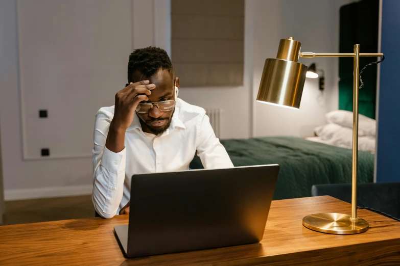 a man sitting in front of a laptop computer, trending on pexels, no lights in bedroom, showing forehead, mkbhd, professional picture