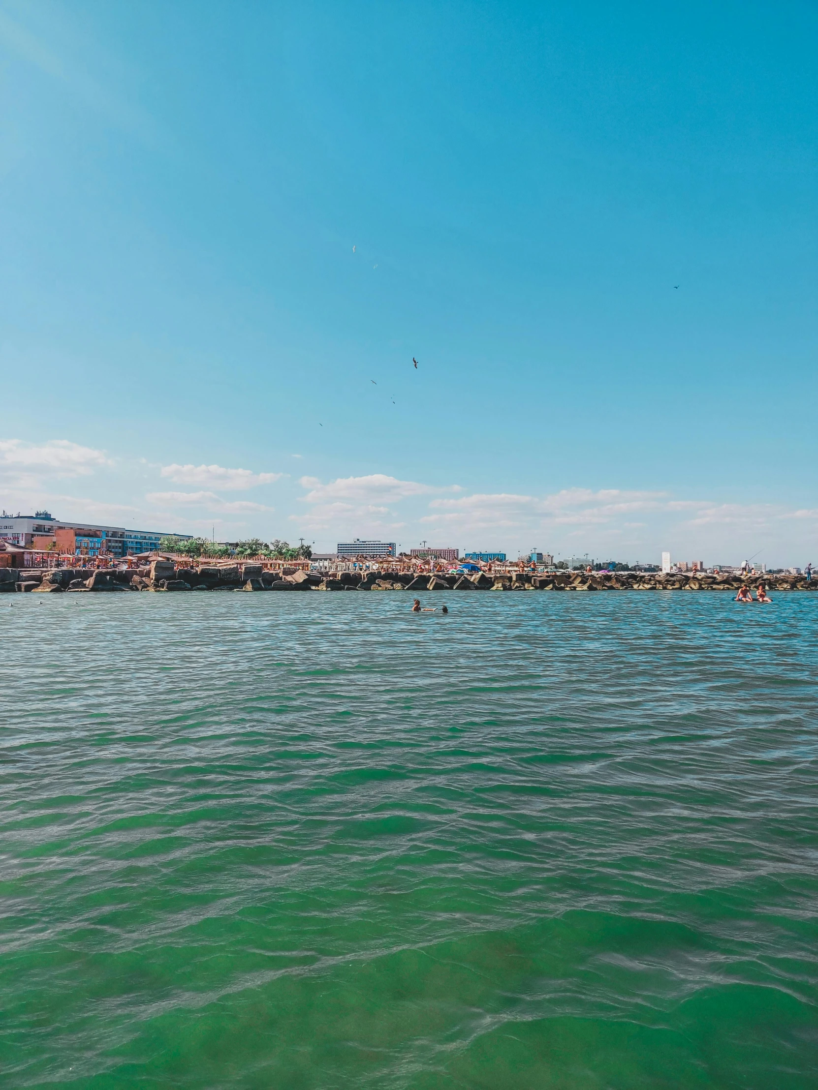 a large body of water next to a beach, a picture, happening, helsinki, profile image, viewed from the ocean, ultra wide angle shot