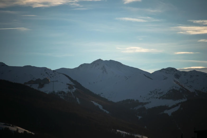 some snow capped mountain tops under a blue sky