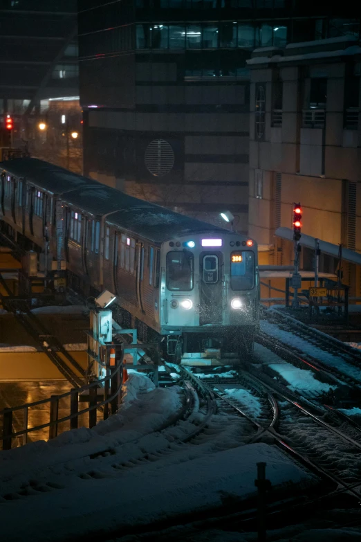 a train is coming down the tracks at night, chicago, homicide in the snow, underground facility, high quality photo