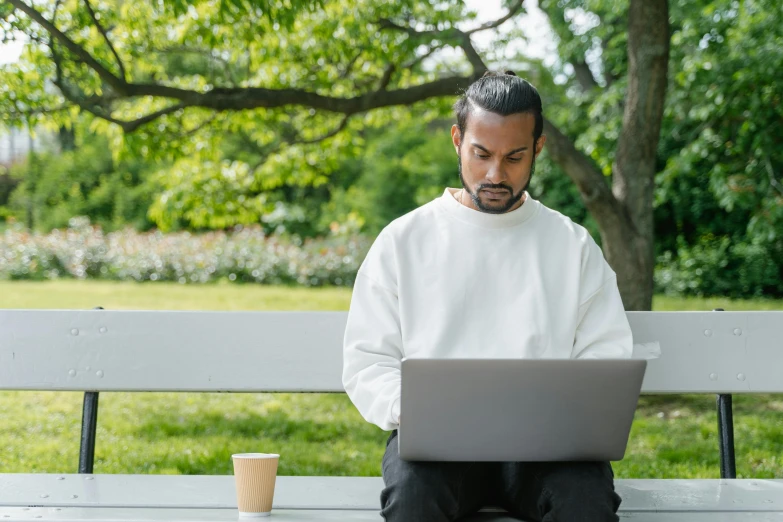 a man sitting on a bench using a laptop, inspired by Christoffer Wilhelm Eckersberg, trending on unsplash, white sleeves, a portrait of rahul kohli, sittin, “hyper realistic