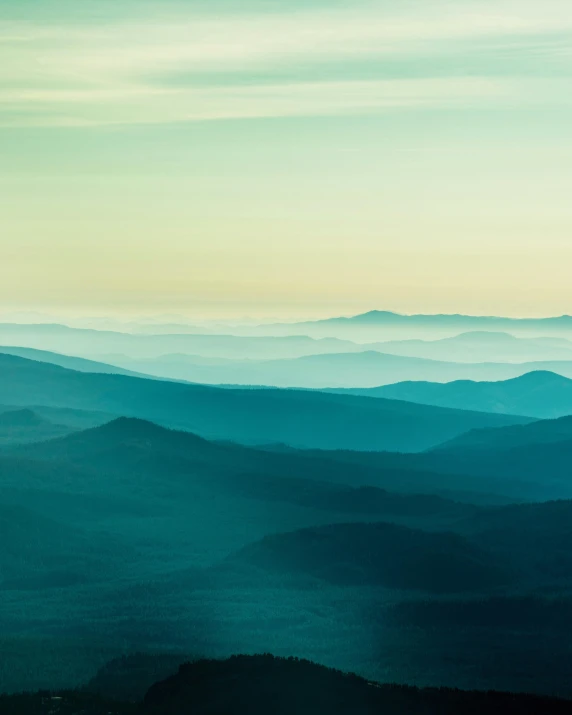 a view of the mountains from the top of a mountain, inspired by Elsa Bleda, unsplash contest winner, hudson river school, gradient white blue green, 3 layers of sky above each other, early evening, muted colours 8 k